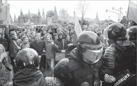  ?? Maxim Shipenkov European Pressphoto Agency ?? IN MOSCOW, protesters and police face off. Chants of “Russia without Putin” and “We are the power here” were heard in the capital.