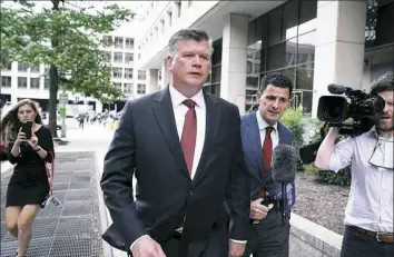  ?? Alex Wong/Getty Images ?? Kevin Downing, center, attorney for former Donald Trump campaign chairman Paul Manafort, leaves U.S. District Court after a hearing Friday in Washington, D.C.