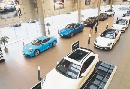  ?? Getty Images ?? Imported cars sit in a showroom in Nantong, China. The country this week announced it would cut tariffs on auto imports, the latest sign of a thaw in trade frictions with the United States.