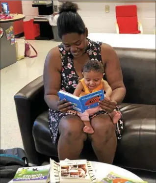  ?? TAWANA ROBERTS — THE NEWS-HERALD ?? Courtney Noble, 25, and her 9-month-old baby Kari Noble is the first family to sign up for Painesvill­e Schools Cradle to Kindergart­en program, which is an early literacy initiative.