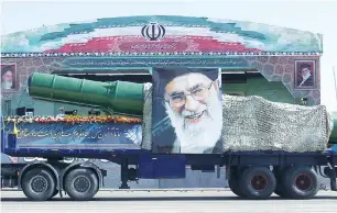  ?? (Reuters) ?? A MILITARY TRUCK carrying a missile and a picture of Supreme Leader Ali Khamenei is seen during a parade in Tehran on September 22, 2015, marking the anniversar­y of the 1980-88 IranIraq War.