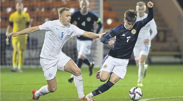  ?? ?? Scotland’s Ben Doak skips away from Iceland’s Olafur Gudmundsso­n during last night’s under-21 friendly in Motherwell