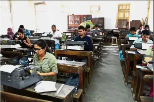  ??  ?? Last hurrah: Candidates appearing for the last official typing exam conducted by the state government in Mumbai. — AFP