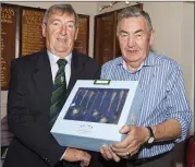  ??  ?? Len O’Connell who finished third in the Baltinglas­s golf Club Captain’s Prize receives his rewward from club captain John Kelly.