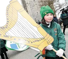  ??  ?? Pictured, top, members of the Comhaltas group celebratin­g St Patrick’s Day. Centre: the Coast Guard crew with the helicopter and right, Scoil Mhuire na Trocaire at the Ardee parade.