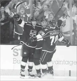  ?? Photograph­s by Gina Ferazzi Los Angeles Times ?? ALEC MARTINEZ, center, is congratula­ted by Tyler Toffoli and Tanner Pearson after scoring at 1:14 of overtime for the Kings against the Blue Jackets.