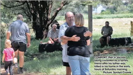  ??  ?? COMFORT: Piet Jr Jacobs being consoled by a family friend after his father was killed in his home in the early hours of Saturday morning.
Picture: Soraya Crowie