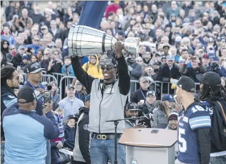  ?? PHOTOS: CHRIS YOUNG/THE CANADIAN PRESS ?? Toronto Argonauts running back James Wilder Jr. hoists the Grey Cup in front of fans gathered Tuesday at Toronto’s Nathan Phillips Square, where the team celebrated its 27-24 win over Calgary Stampeders at the 105th Grey Cup in Ottawa.