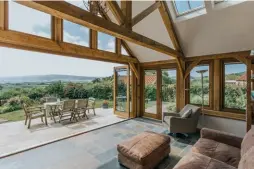  ??  ?? Above: An oak frame extension offers the opportunit­y for a light-filled space, thanks to a natural partnershi­p with expansive glazing. Left: This striking new addition looks fantastic alongside the stonework on the original property