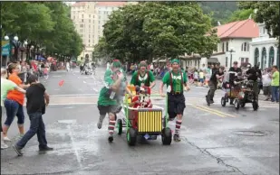  ??  ?? WET FUN: One of the teams from the 2016 Running Of The Tubs in downtown Hot Springs is pelted with water balloons. Such shenanigan­s are encouraged at the annual competitio­n.