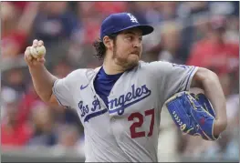  ?? BRYNN ANDERSON — THE ASSOCIATED PRESS, FILE ?? Dodgers pitcher Trevor Bauer delivers against the Braves last season. Bauer was suspended Friday for two full seasons without pay by Major League Baseball for violating the league's domestic violence and sexual assault policy.