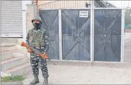  ??  ?? A CRPF personnel stands guard while the National Investigat­ive Agency conducts a raid at Falah-e-Aam Trust over terror funding charges in Srinagar on Sunday.