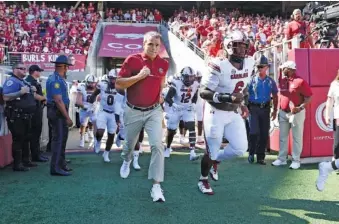  ?? AP PHOTO/MICHAEL WOODS ?? South Carolina coach Shane Beamer leads his team onto the field to play Arkansas on Saturday.