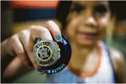  ?? Brett Coomer / Houston Chronicle ?? The lifetime wait of Marylin Basaldu, 5, wasn’t too long, but she was no less proud of her replica ring.