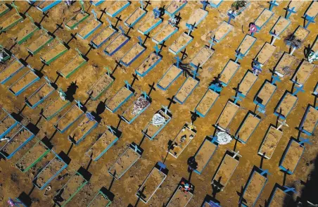  ?? Michael Dantas / AFP / Getty Images ?? Newly dug graves at the Nossa Senhora Aparecida cemetery in Manaus, Brazil, reflect the grim toll of the COVID19 pandemic.