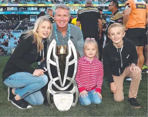  ?? Picture: GETTY IMAGES ?? Garth Brennan, with his family after winning the 2017 State Championsh­ip Final, looms as a genuine contender for the Gold Coast NRL job.