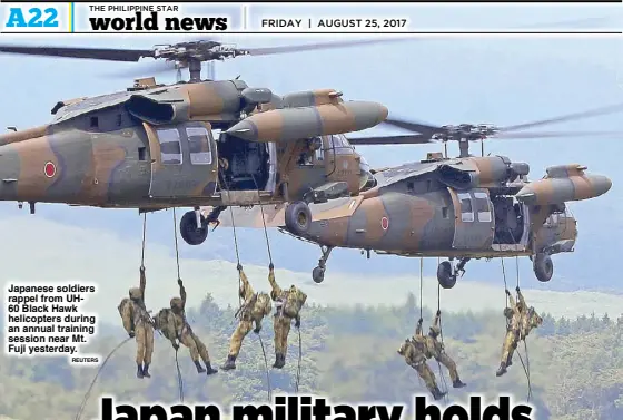  ?? REUTERS ?? Japanese soldiers rappel from UH60 Black Hawk helicopter­s during an annual training session near Mt. Fuji yesterday.