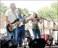  ??  ?? Chris Lynch with Boston Mountain Playboys sings during one of the sets performed by the band Saturday at Lincoln’s Chicken Rod Nationals Car Show.