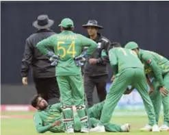  ??  ?? BIRMINGHAM: Pakistan’s Mohammad Amir winces in pain after an injury during the ICC Champions Trophy match between India and Pakistan at Edgbaston in Birmingham. — AP