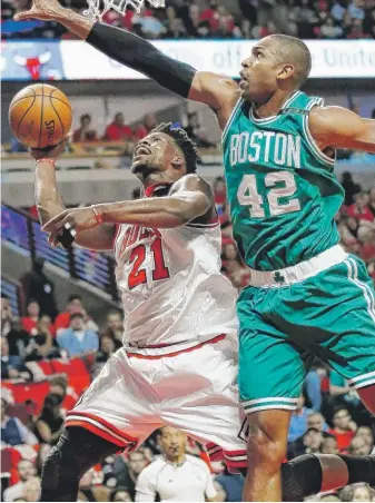  ?? | NAMY. HUH/ AP ?? Jimmy Butler, driving to the basket against Celtics center Al Horford, had 23 points in Game 6.