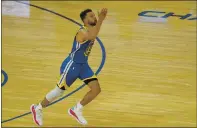  ?? JEFF CHIU — THE ASSOCIATED PRESS ?? Warriors guard Stephen Curry gestures after scoring against the Nuggets to pass Wilt Chamberlai­n to become the franchise’s alltime leading scorer during the first half on Monday.