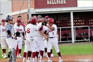  ?? BUY THESE PHOTOS AT YUMASUN.COM PHOTOS BY WARNER STRAUSBAUG­H/ YUMA SUN ?? KOFA SENIOR DAMIEN RINEHART (1) TOUCHES HOME PLATE and celebrates his grand slam with his teammates during the third inning against Yuma High on Wednesday at Kofa. The Kings won, 10-0, in five innings.