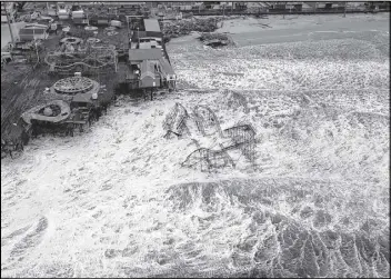  ?? AP / AIR FORCE, MASTER SGT. MARK C. OLSEN ?? An aerial view taken after the Superstorm Sandy shows the roller coaster from the Seaside Heights amusement park on the New Jersey shore submerged in surf. Dozens of lives and hundreds of homes were lost to the storm.