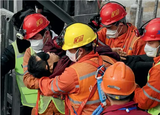  ?? AP ?? In this photo released by Xinhua News Agency, rescuers carry a miner who was trapped in a mine to an ambulance in Qixia City in east China’s Shandong Province.
