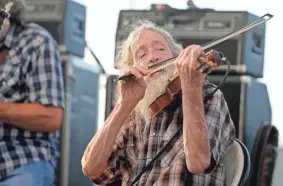  ?? FILE BRYAN TERRY/THE OKLAHOMAN ?? Randy Crouch performs with the Red Dirt Rangers during the Woody Guthrie Folk Festival in Okemah, Okla., Thursday, July 12, 2018.