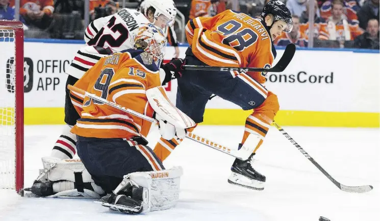  ?? DAVID BLOOM ?? Edmonton Oilers goalie Mikko Koskinen kicks out a shot against the Chicago Blackhawks Thursday at Rogers Place. Koskinen had 40 saves in a 4-0 victory.