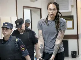  ?? AP photo ?? WNBA star Brittney Griner is escorted from a court room after a hearing in Khimki just outside Moscow, Russia, on Thursday.