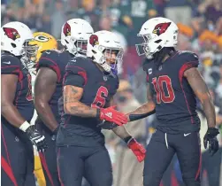  ?? MICHAEL CHOW/THE REPUBLIC ?? Cardinals RB James Conner (6) is congratula­ted by WR DeAndre Hopkins after running for a touchdown against Green Bay on Oct. 28.