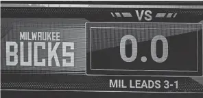  ??  ?? The game clock sits at 0.0 after the scheduled start time of Game 5 between the Bucks and Magic. KEVIN C. COX/ POOL PHOTO