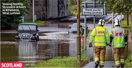  ??  ?? Sinking feeling: Stranded drivers in Kirkliston, West Lothian