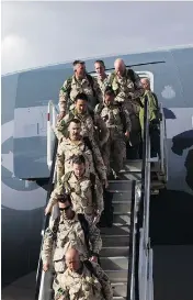  ?? AMBER BRACKEN / POSTMEDIA NEWS FILES ?? Soldiers disembark from Afghanista­n at Edmonton airport. The Canadian Forces are allowing its members to wear beards, though only up to 2 centimetre­s in length.