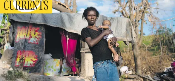  ?? PHOTOS: SARAH L. VOISIN / THE WASHINGTON POST ?? Nicole Duce, 43, holds her five-month-old daughter in Port-Salut, Haiti. Emergency aid is arriving for those who lost nearly everything when hurricane Matthew tore through the country last month, but there is not enough of it and it will take several...