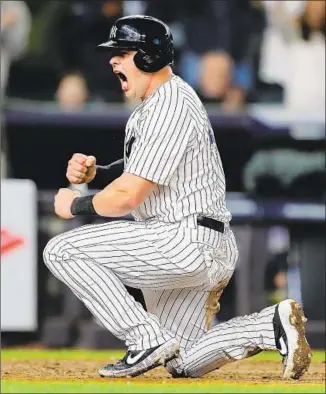  ?? Elsa Garrison Getty Images ?? NEW YORK’S Luke Voit celebrates after scoring on a sacrifice fly by Didi Gregorius in the sixth inning, giving the Yankees a 6-0 lead over Oakland. The close play was upheld by a replay.