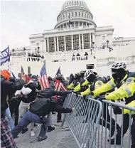  ?? JULIO CORTEZ/ AP ?? Rioters attack the Capitol on Jan. 6 in Washington.