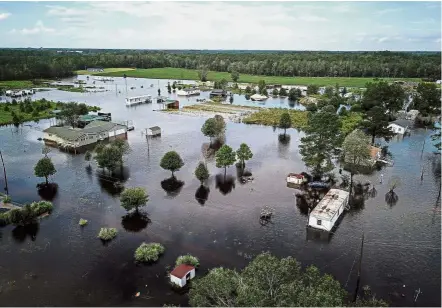  ?? — Bloomberg ?? Under water: A flooded neighbourh­ood standing next to the Lumber River in this aerial photograph taken after Hurricane Florence hit Lumberton, North Carolina.