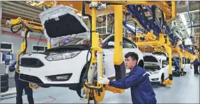  ?? LIU YANG / FOR CHINA DAILY ?? Workers assemble cars at a Ford production line in Harbin, Heilongjia­ng province.