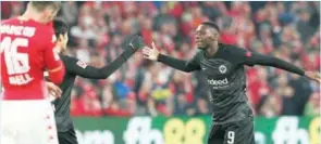  ?? ?? Frankfurt’s French Randal Kolo Muani (right) celebrates after scoring a goal during the German first division Bundesliga match in Mainz recently. (AFP)