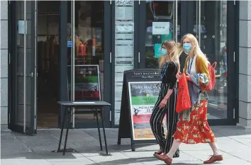  ?? AFP ?? Residents walk in central in Aberdeen, eastern Scotland on Wednesday. The port city has imposed a local lockdown after recording a spike in the number of coronaviru­s cases.