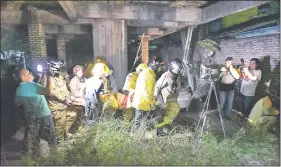  ??  ?? Bomberos voluntario­s y paramédico­s trasladan a la víctima hasta una ambulancia, luego de ser rescatada del profundo pozo donde se precipitó.