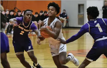  ?? AUSTIN HERTZOG - MEDIANEWS GROUP ?? Perkiomen Valley’s Julian Sadler splits Upper Darby defenders Khysir Slaughter (1) and Lovo Mulbah (2) on a drive in a District 1-6A second round game on Feb. 21at Perkiomen Valley.