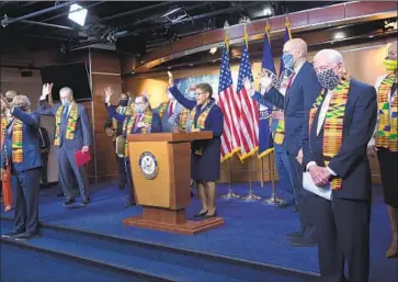  ?? Caroline Brehman Associated Press ?? REP. KAREN BASS (D-Los Angeles), center, joins other Democrats in the House and Senate in proposing a bill to change policing. Bass and California Sen. Kamala Harris spearheade­d the legislatio­n, unveiled Monday.