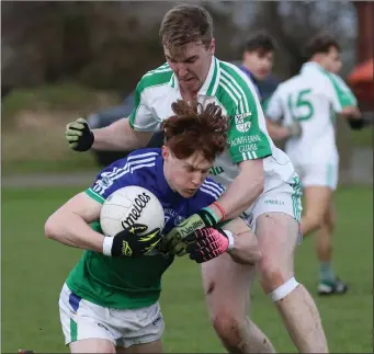  ??  ?? James Stafford (Glynn-Barntown) goes to ground as Jack Cullen (Naomh Eanna) challenges.