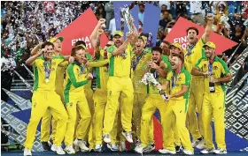  ?? Picture: Alex Davidson ?? Aaron Finch holds the trophy aloft as Australia celebrate winning the T20 World Cup after beating New Zealand in the final