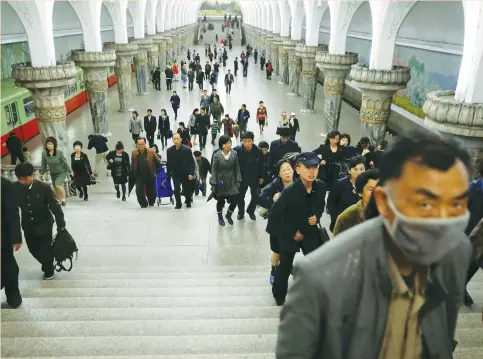  ??  ?? PEOPLE LEAVE a subway station in Pyongyang earlier this month. The North Korean government is likely the country’s largest consumer of fuel products, but most gasoline and diesel bought by ordinary North Koreans is supplied by private dealers and...