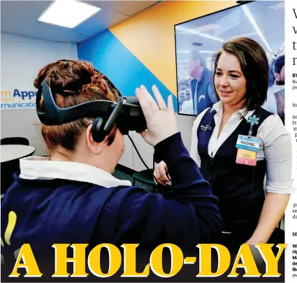  ?? [PHOTOS BY STEVE SISNEY, THE OKLAHOMAN] ?? Walmart facilitato­r Rachel Murray, right, helps Department Manager April Major use a virtual reality training device at a recent academy class at the retailer’s super center in Del City.