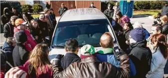  ?? Travis Long / The News & Observer via Associated Press ?? Demonstrat­ors surround a government vehicle holding undocument­ed Mexican national Samuel Oliver-Bruno, 47, who was arrested Friday in Morrisvill­e, N.C.